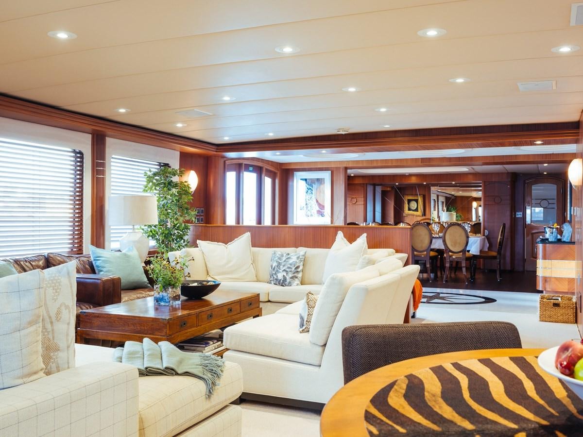 a living room with a couch and a table aboard DAYDREAM Yacht for Sale