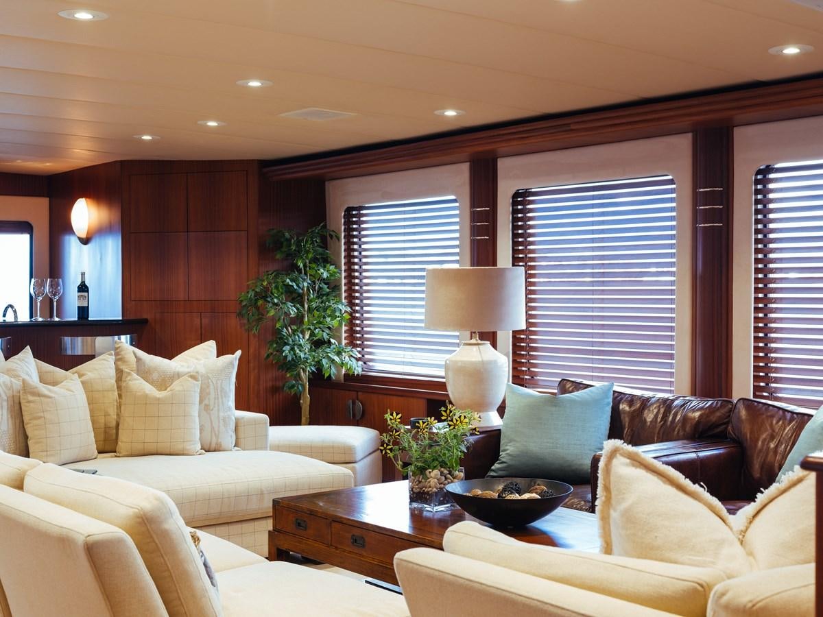 a living room with a couch and a coffee table aboard DAYDREAM Yacht for Sale