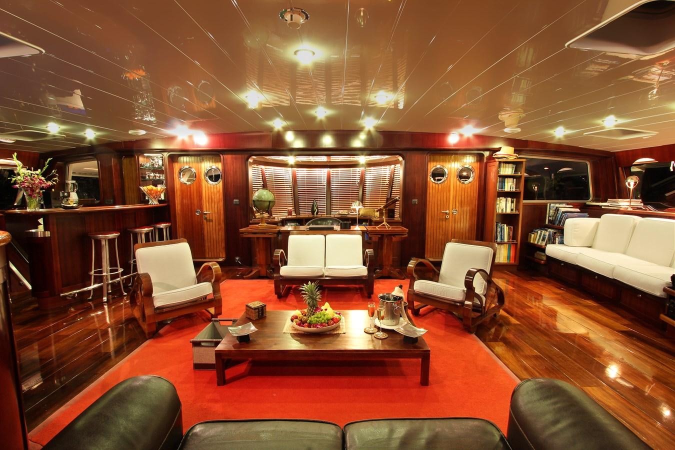 a living room with a large fireplace aboard DOUCE FRANCE Yacht for Sale