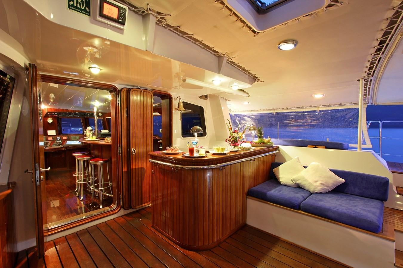 a room with a table and a couch aboard DOUCE FRANCE Yacht for Sale
