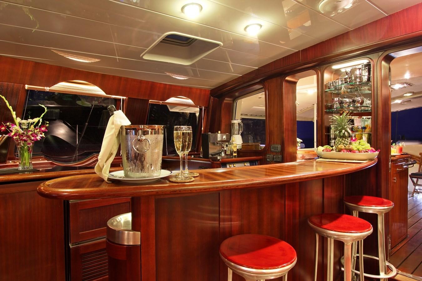a bar with a bar and stools aboard DOUCE FRANCE Yacht for Sale