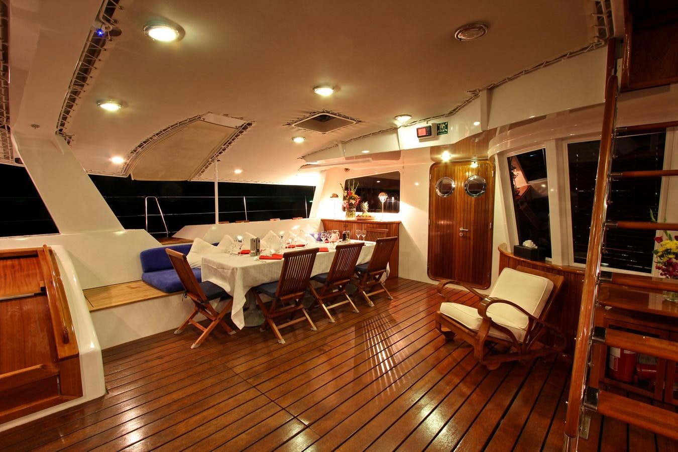 a room with a table chairs and a ladder aboard DOUCE FRANCE Yacht for Sale