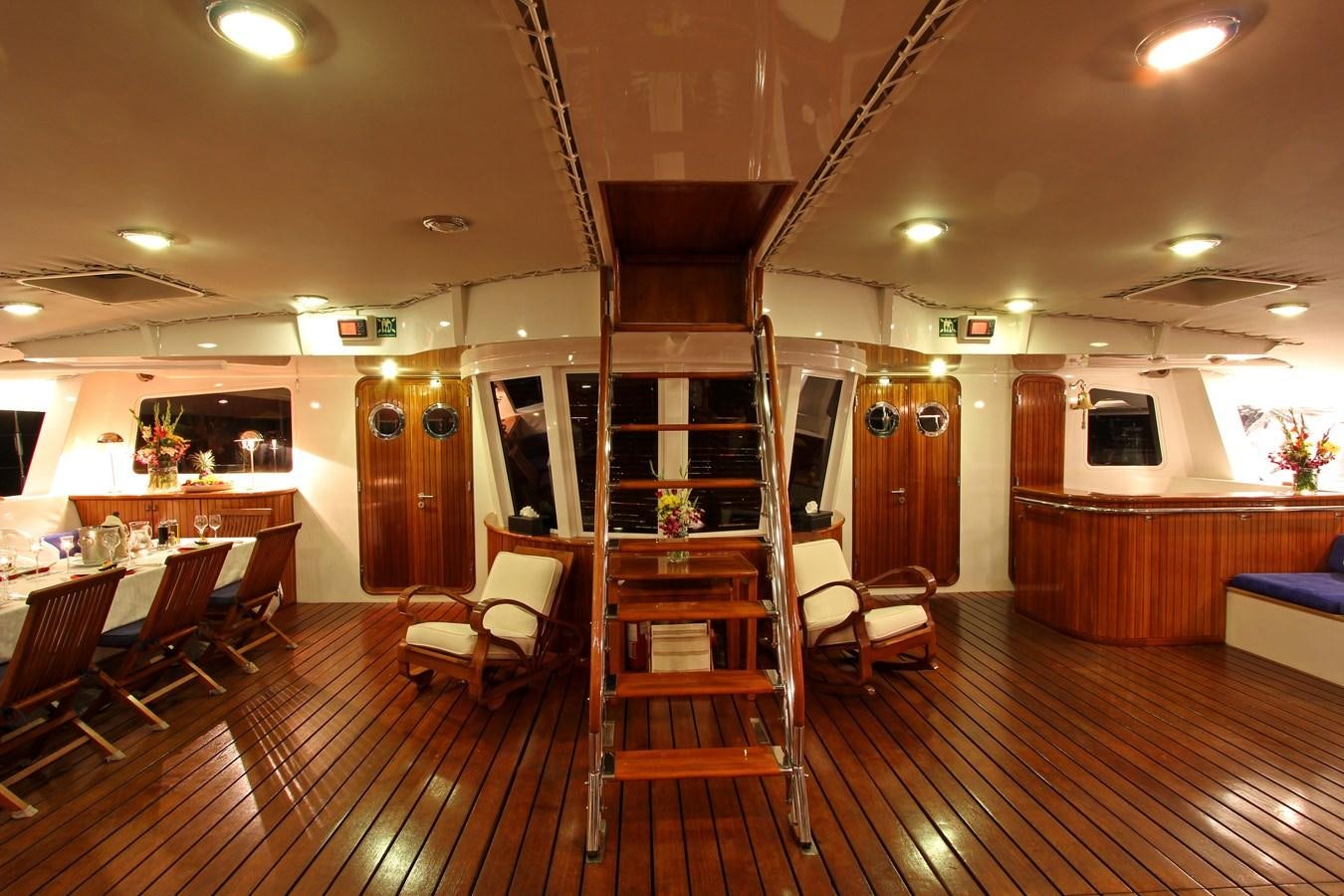 a room with a wood floor and chairs and a wood floor aboard DOUCE FRANCE Yacht for Sale