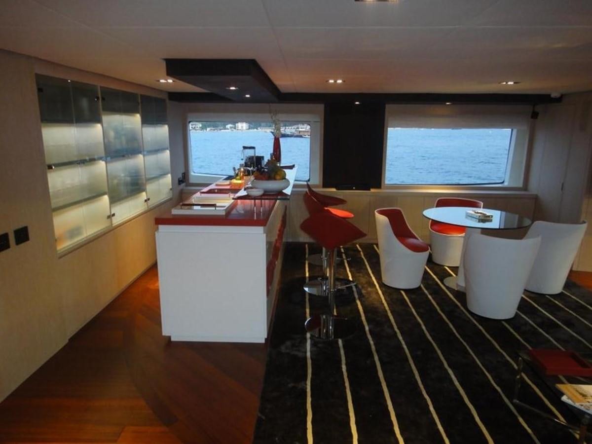 a room with a black and white checkered floor and red chairs aboard BLUE EAST Yacht for Sale