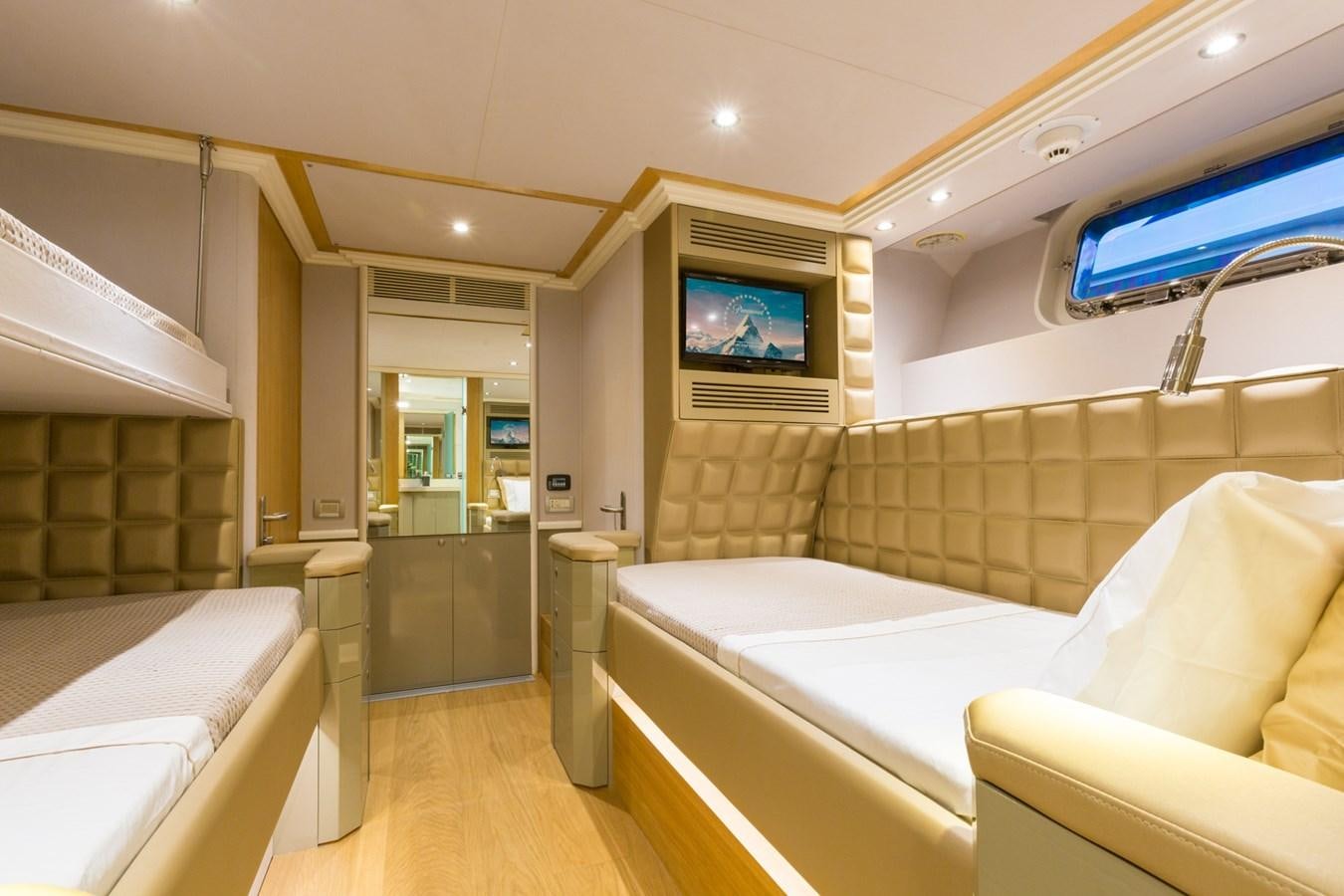 a room with a bed and a tv on the wall aboard AQUARELLA Yacht for Sale