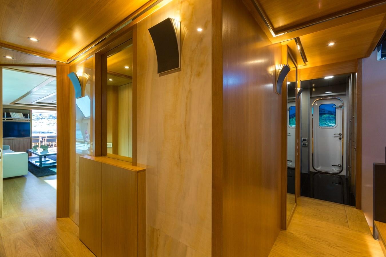 a room with a wood floor and a door with a mirror on the wall aboard AQUARELLA Yacht for Sale