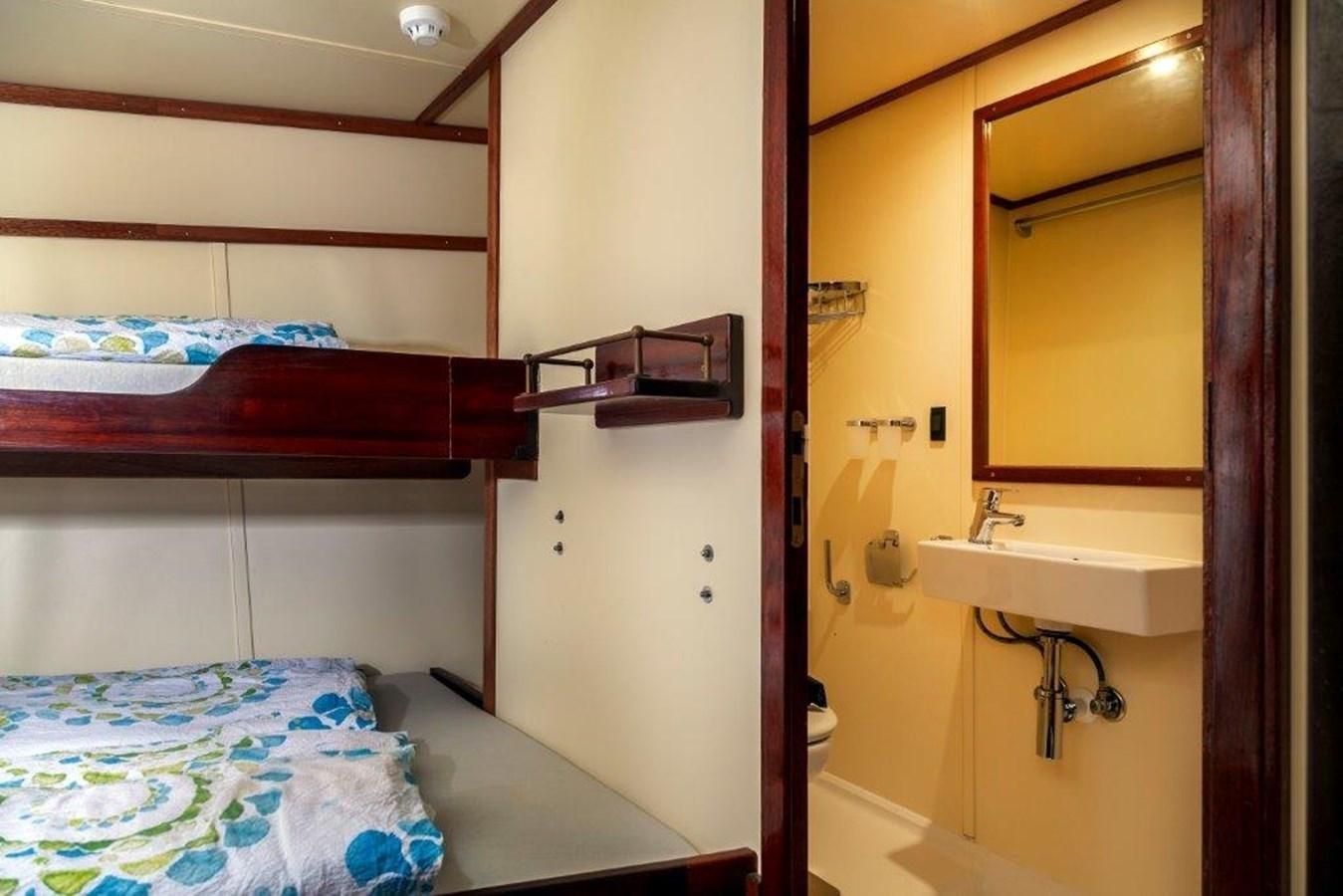 a small bedroom with a bed aboard SIR ROBERT BADEN POWELL Yacht for Sale