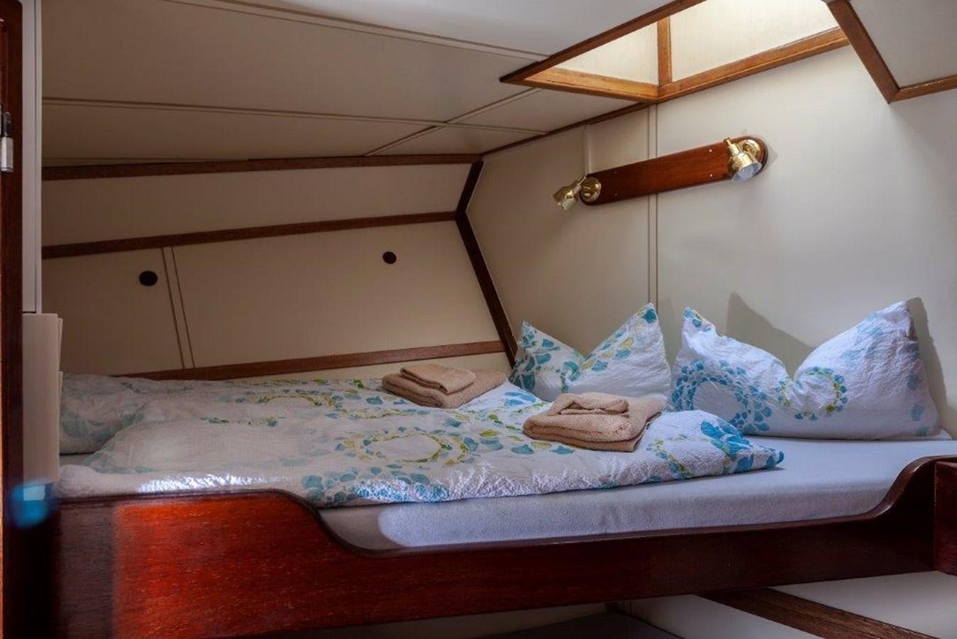 a bed with a lamp on top aboard SIR ROBERT BADEN POWELL Yacht for Sale