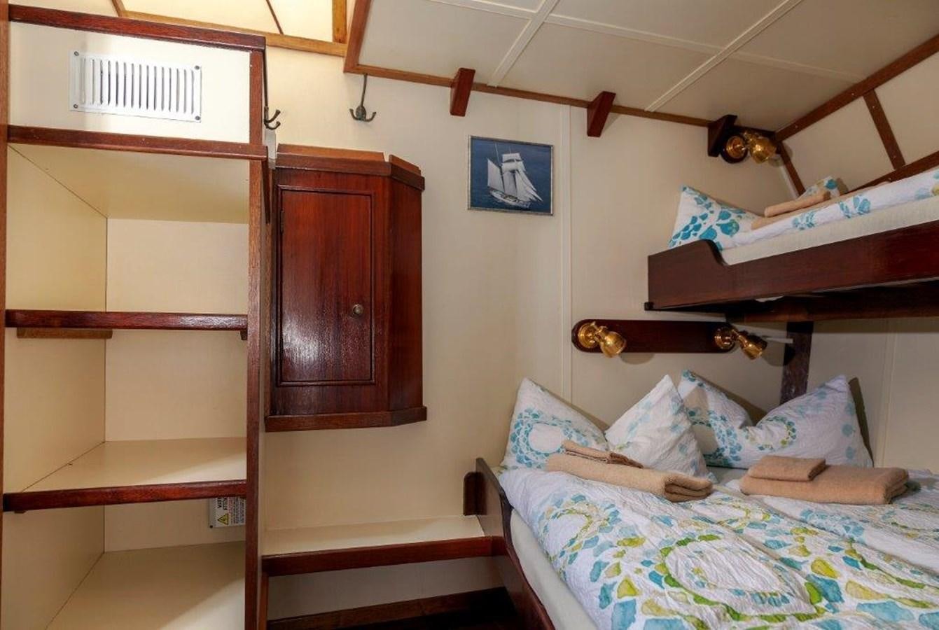 a room with a bed and a closet aboard SIR ROBERT BADEN POWELL Yacht for Sale