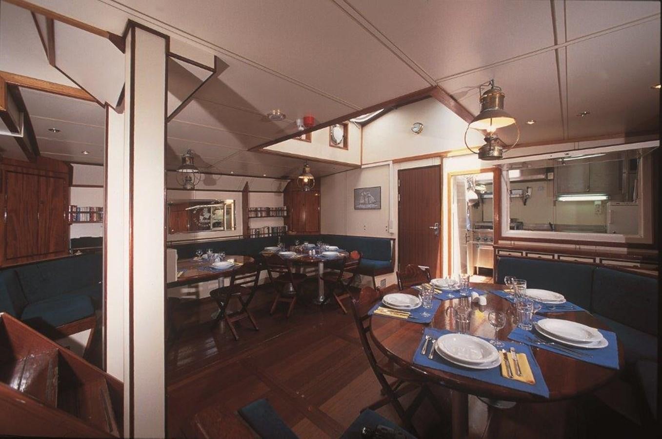 a dining room with a table and chairs aboard SIR ROBERT BADEN POWELL Yacht for Sale