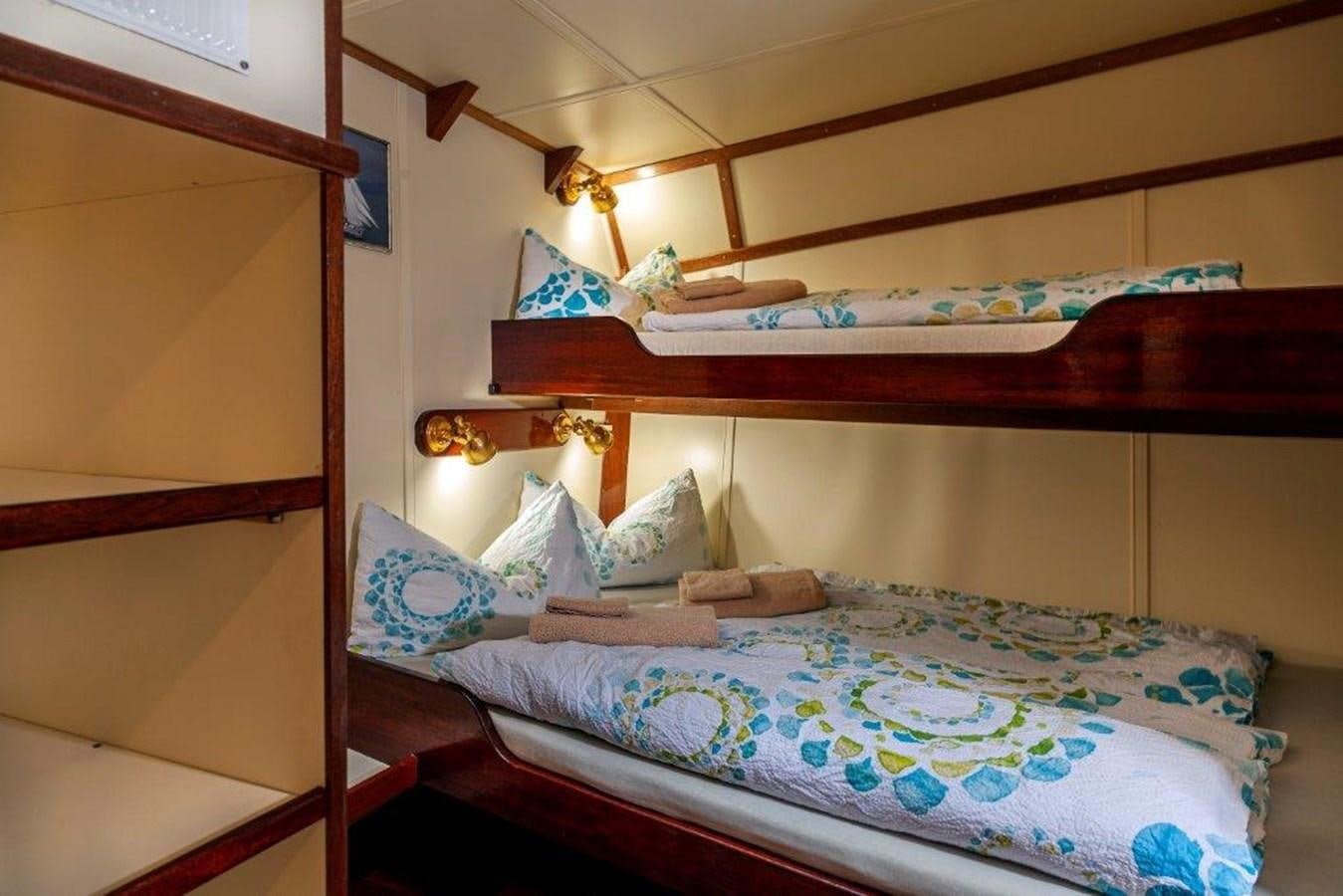 a bed with a couple of beds aboard SIR ROBERT BADEN POWELL Yacht for Sale
