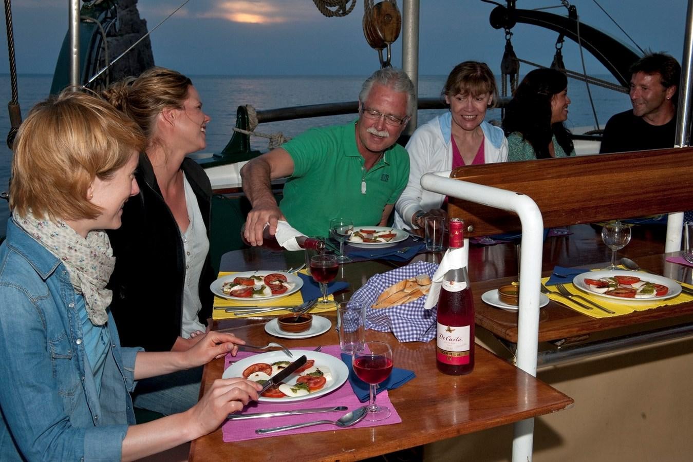 a group of people eating at a restaurant aboard SIR ROBERT BADEN POWELL Yacht for Sale