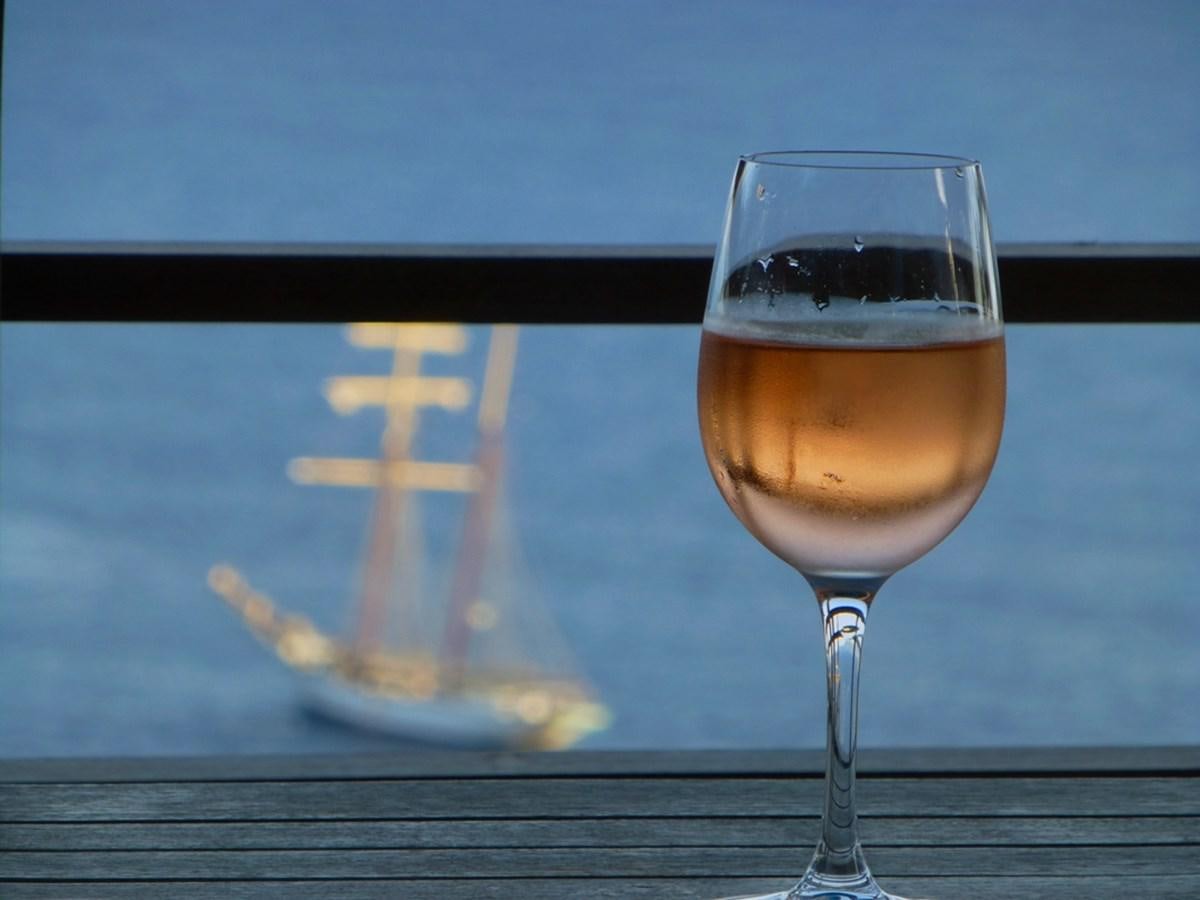 a glass of wine on a table aboard SIR ROBERT BADEN POWELL Yacht for Sale