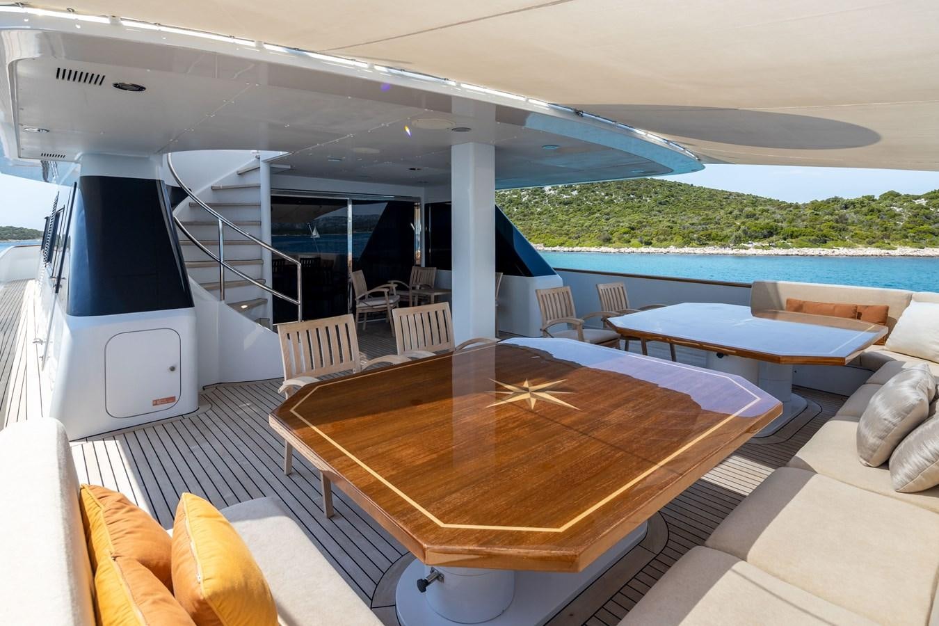 a deck with a table and chairs aboard LADYSHIP Yacht for Charter