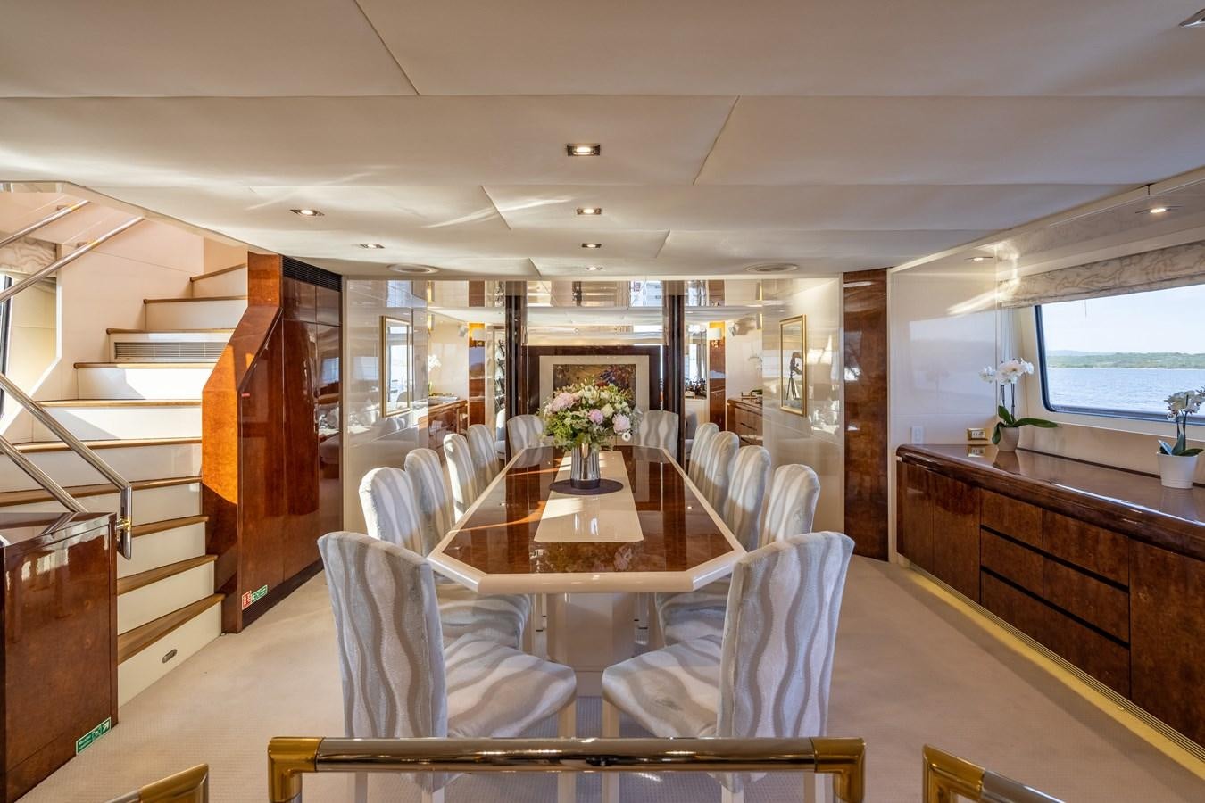 a large dining room with a wood table and chairs aboard LADYSHIP Yacht for Charter