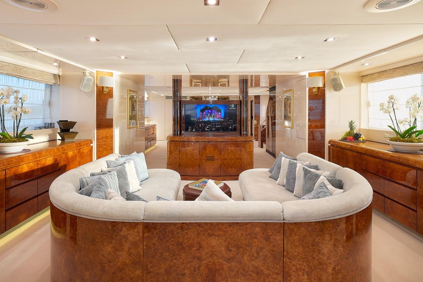 a living room with a large television aboard LADYSHIP Yacht for Charter