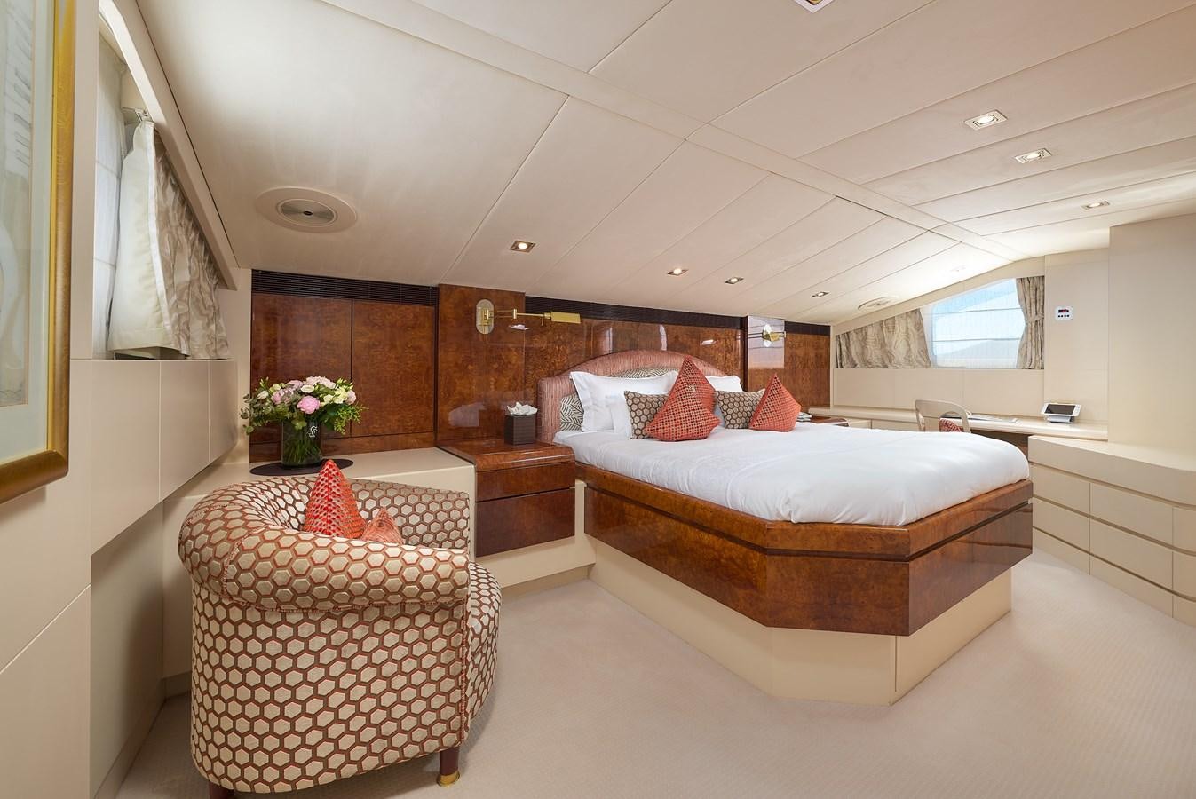 a room with a bed and a chair aboard LADYSHIP Yacht for Sale