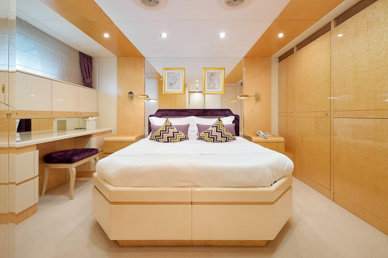 a room with a bed and desk aboard LADYSHIP Yacht for Sale