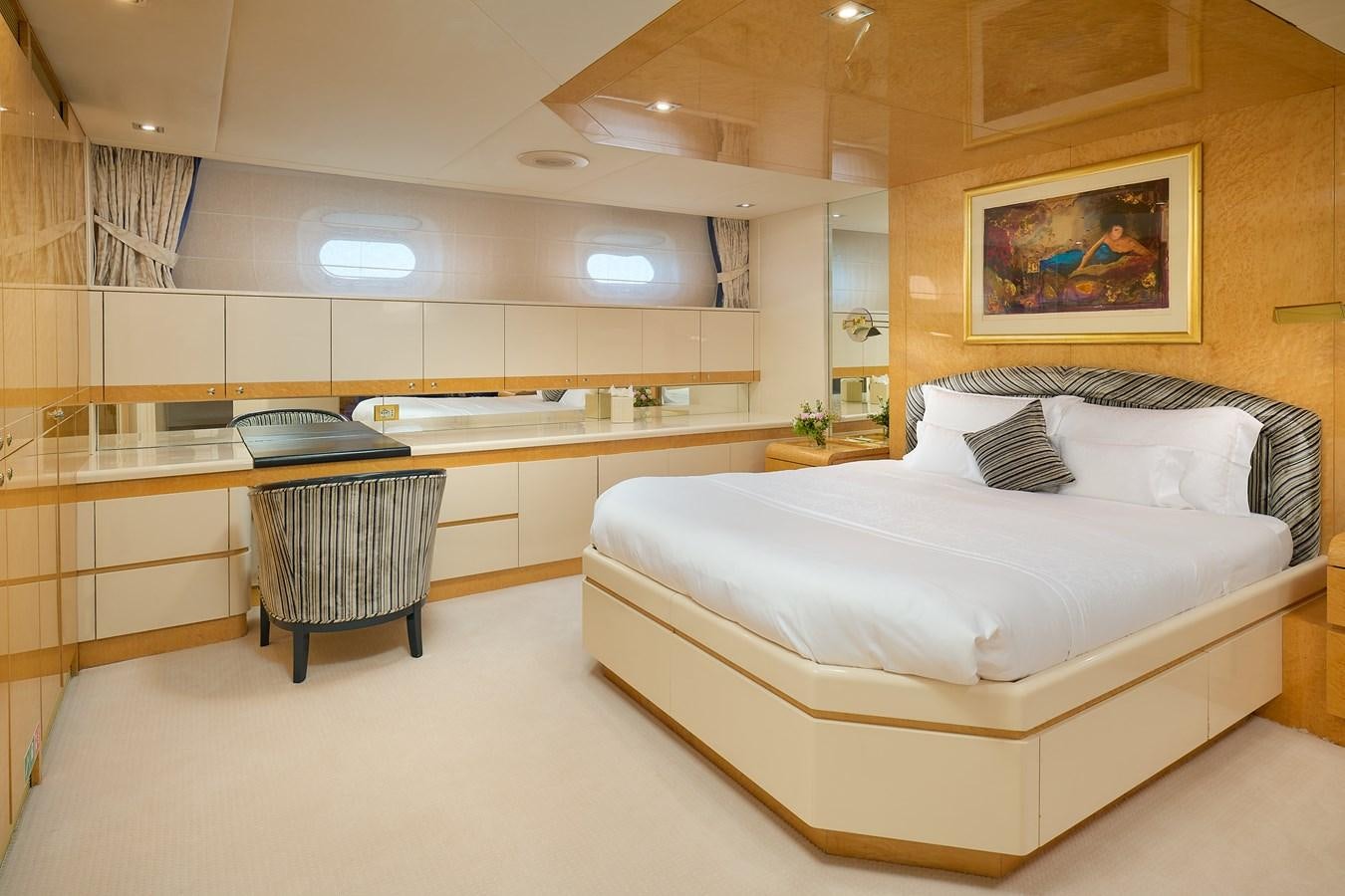 a room with a bed and a desk aboard LADYSHIP Yacht for Charter