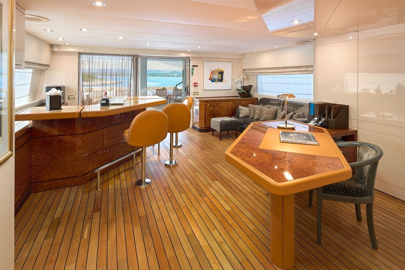 a room with a table chairs and a couch aboard LADYSHIP Yacht for Charter