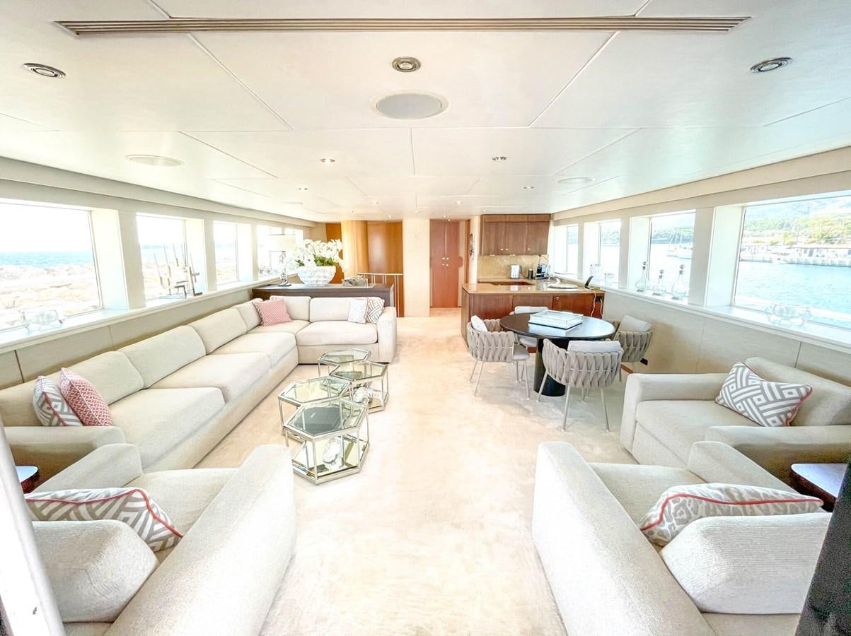 a living room with white couches aboard ENVY Yacht for Sale