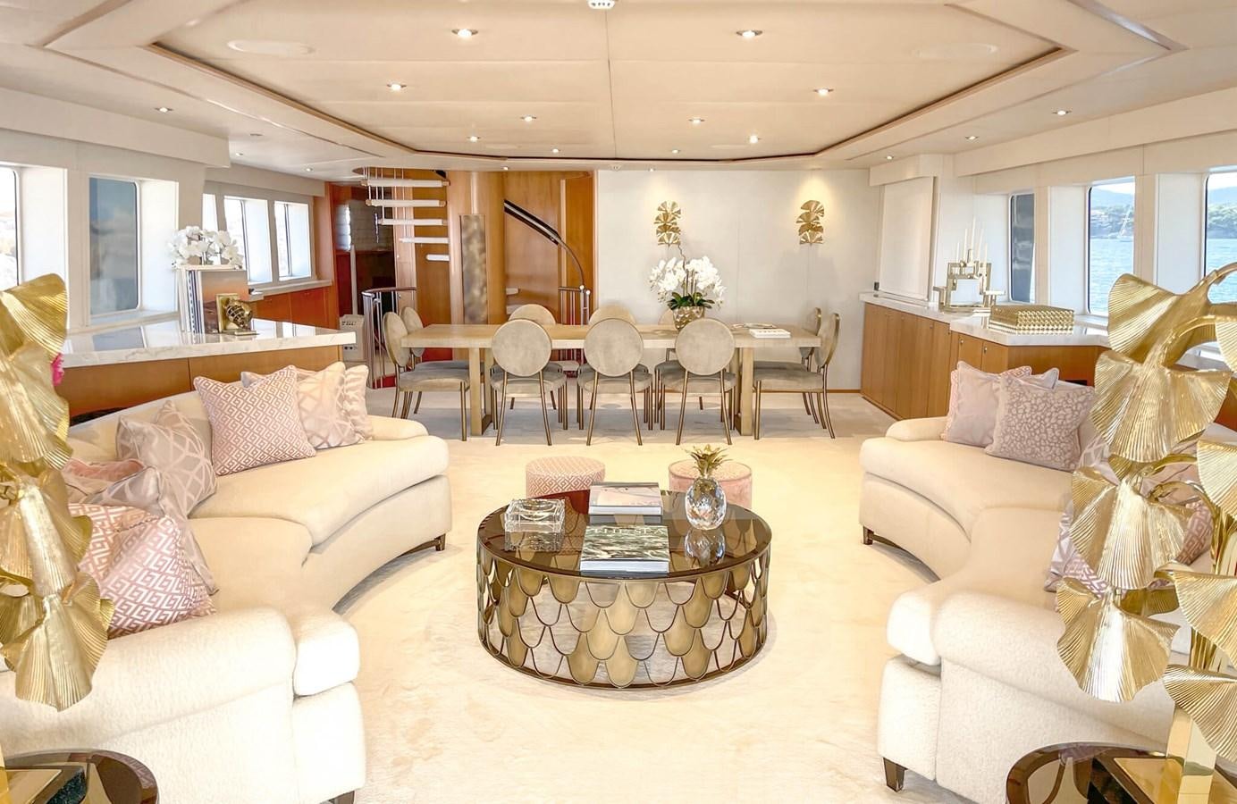 a living room with a table and chairs aboard ENVY Yacht for Sale