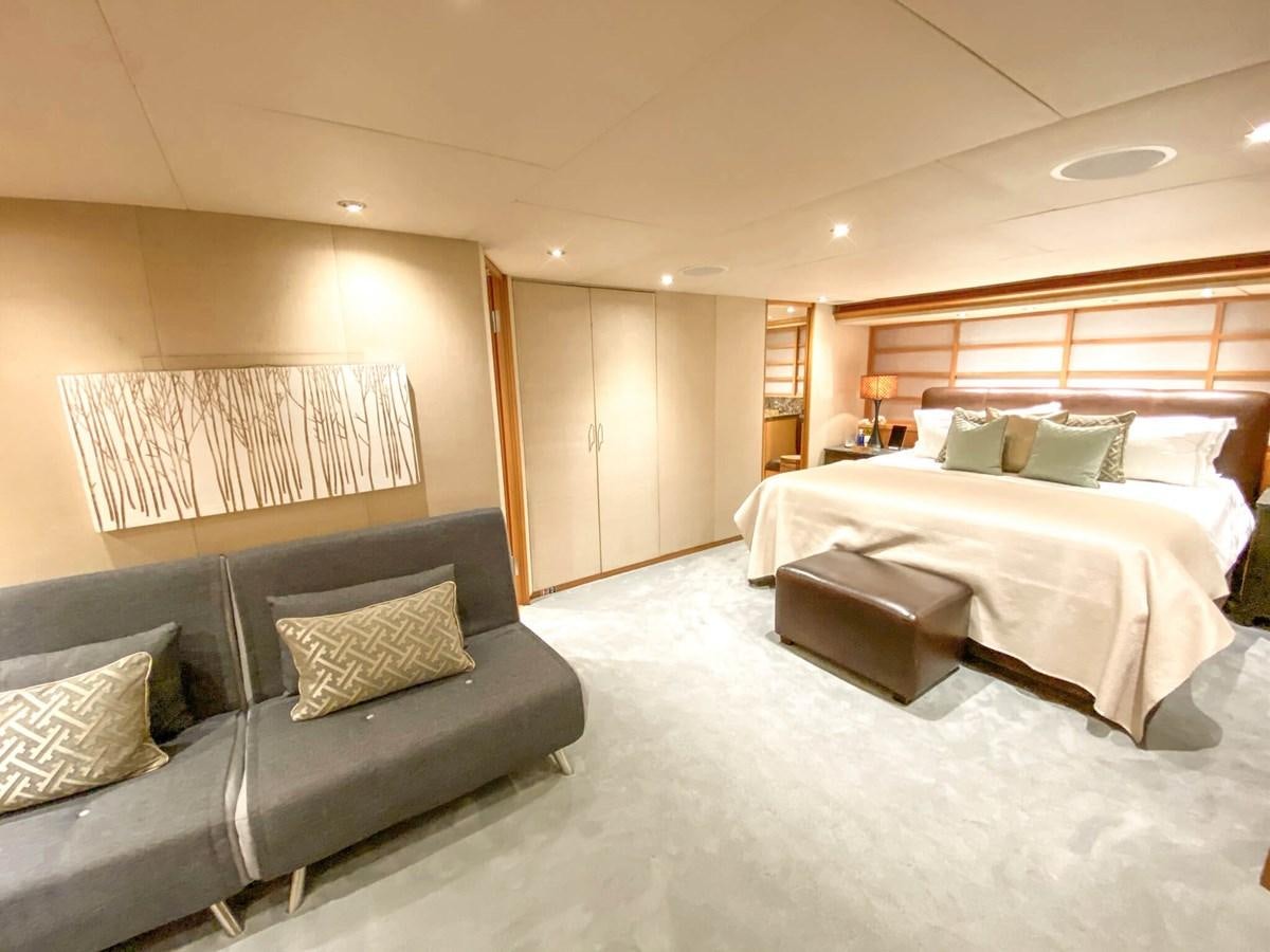 a bed and a couch in a room aboard ENVY Yacht for Sale