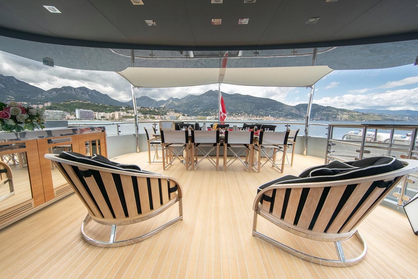 a deck with chairs and tables on it aboard MAESTRO Yacht for Sale