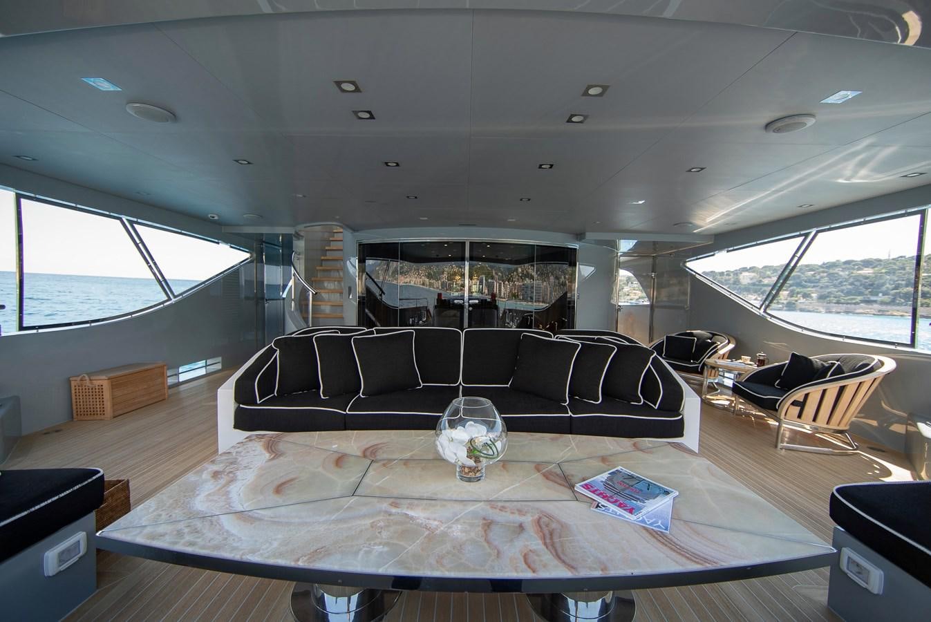 a living room with a couch and a table aboard MAESTRO Yacht for Sale