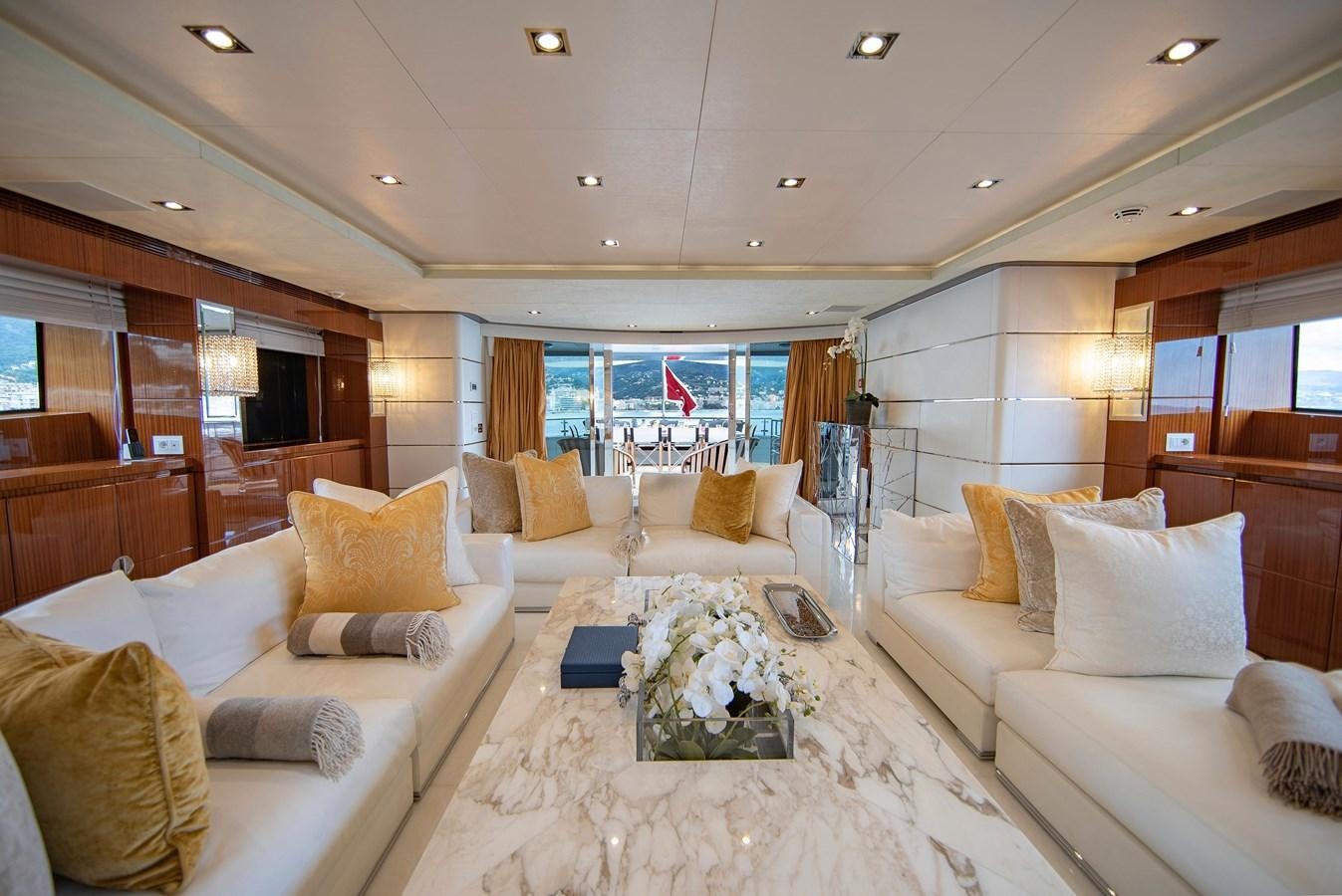a living room with a large white table and a large window aboard MAESTRO Yacht for Sale