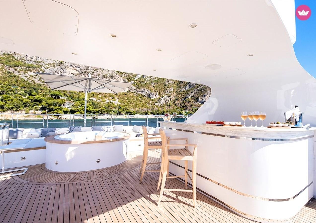 a table and chairs on a patio aboard MY WAY V Yacht for Sale