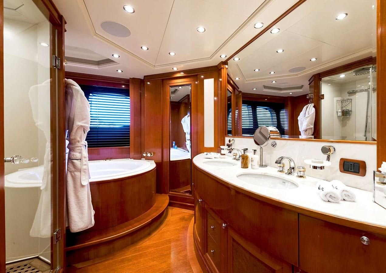 a bathroom with a tub sink and a sink aboard MY WAY V Yacht for Sale
