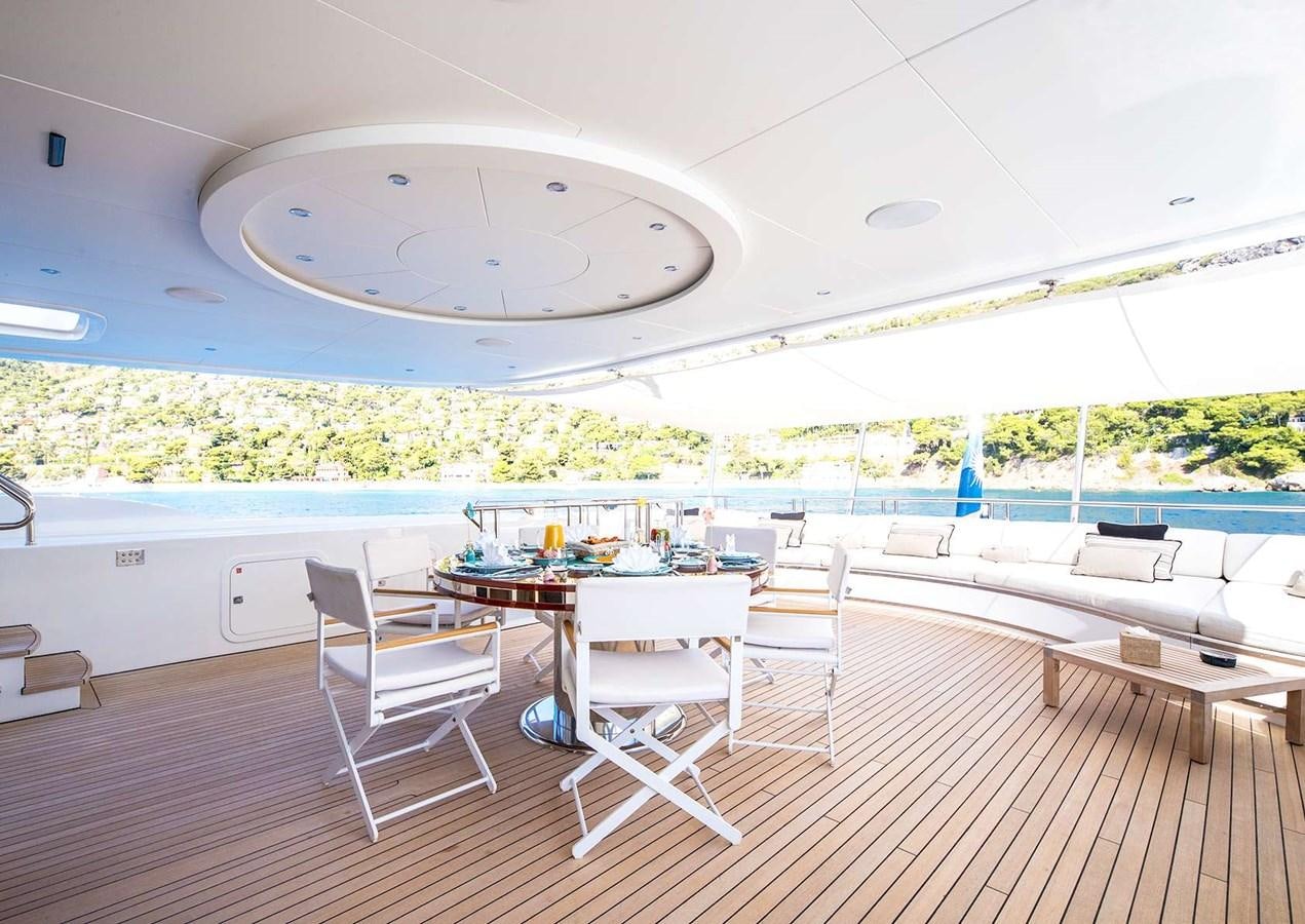 a room with a table chairs and a large wall with a large window aboard MY WAY V Yacht for Sale