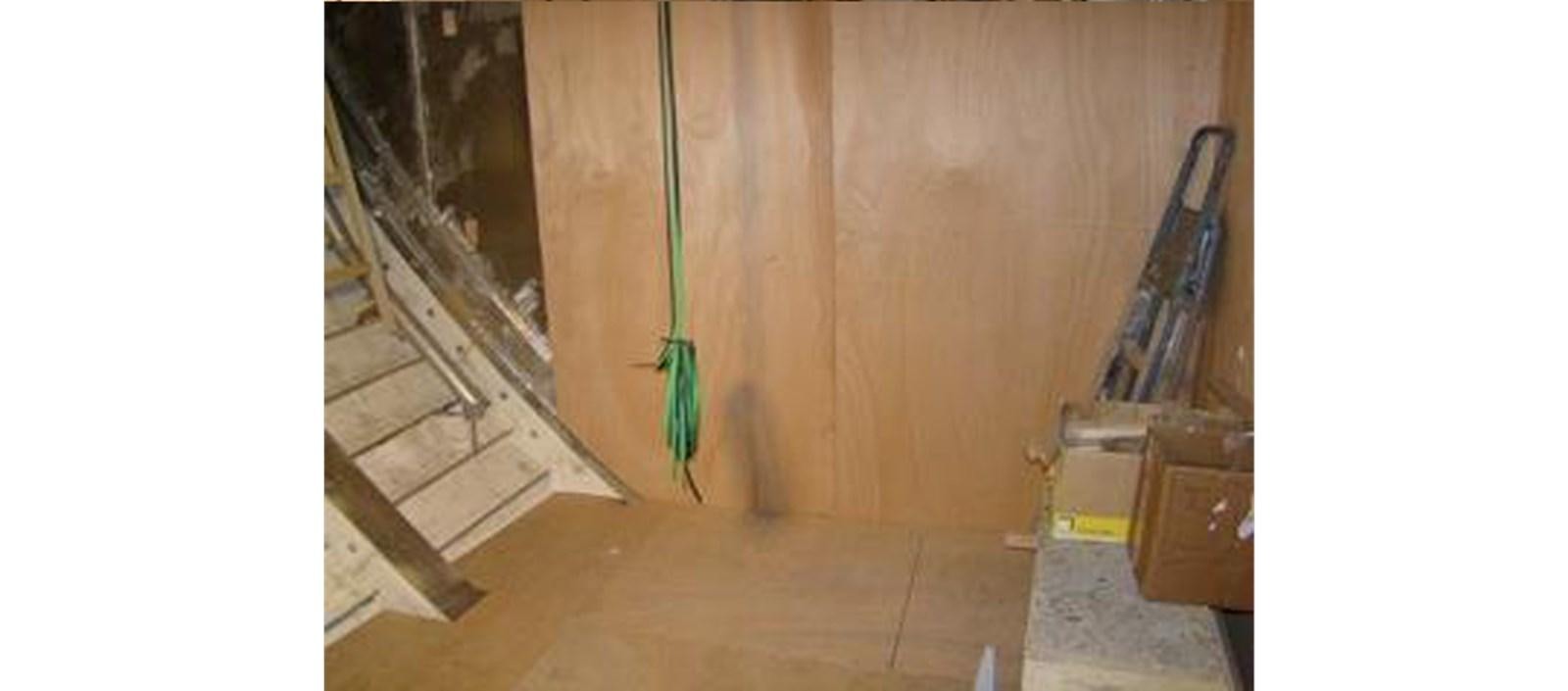 a room with a wood floor and a green object on the floor aboard C-347 Yacht for Sale