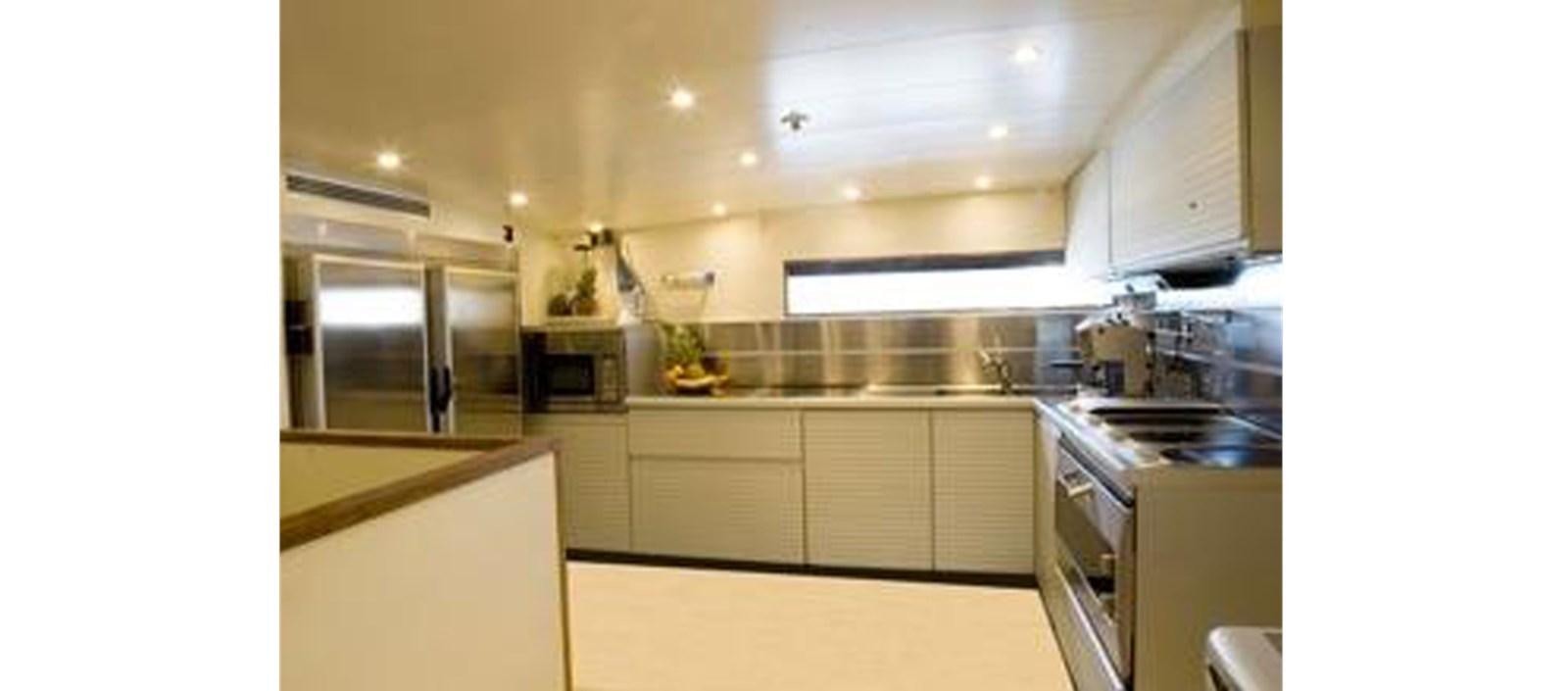 a kitchen with white cabinets aboard C-347 Yacht for Sale