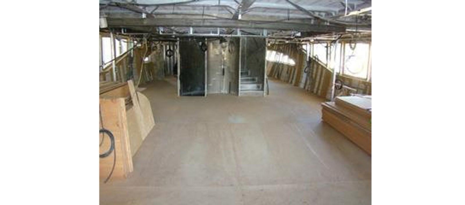 a room with wooden floors and a large room with wood walls aboard C-347 Yacht for Sale