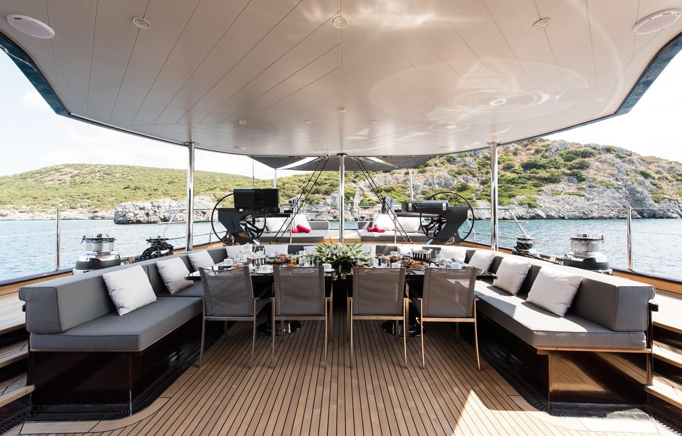 a large patio with a large body of water and a large boat aboard ROX STAR Yacht for Charter