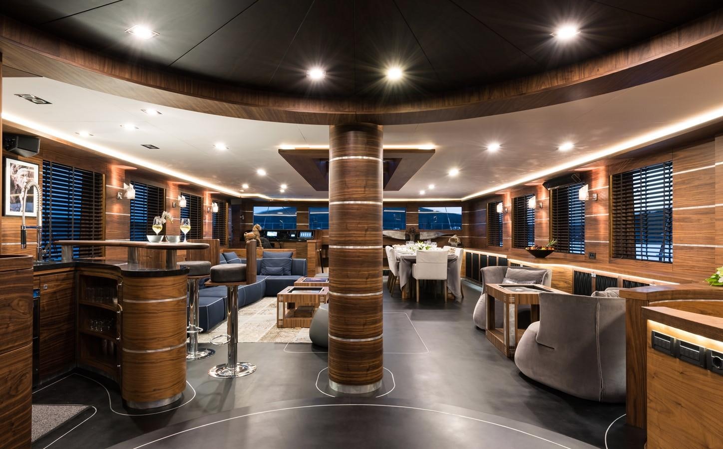 a large room with a large wood column and a large wood table aboard ROX STAR Yacht for Charter