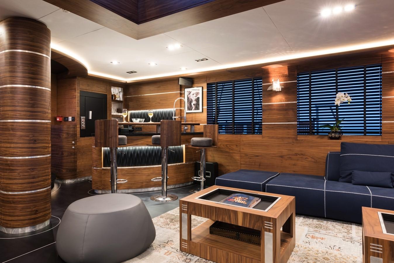 a living room with a blue couch aboard ROX STAR Yacht for Charter