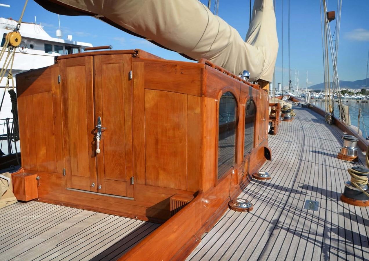 a wooden boat on a deck aboard CANDIDA Yacht for Sale