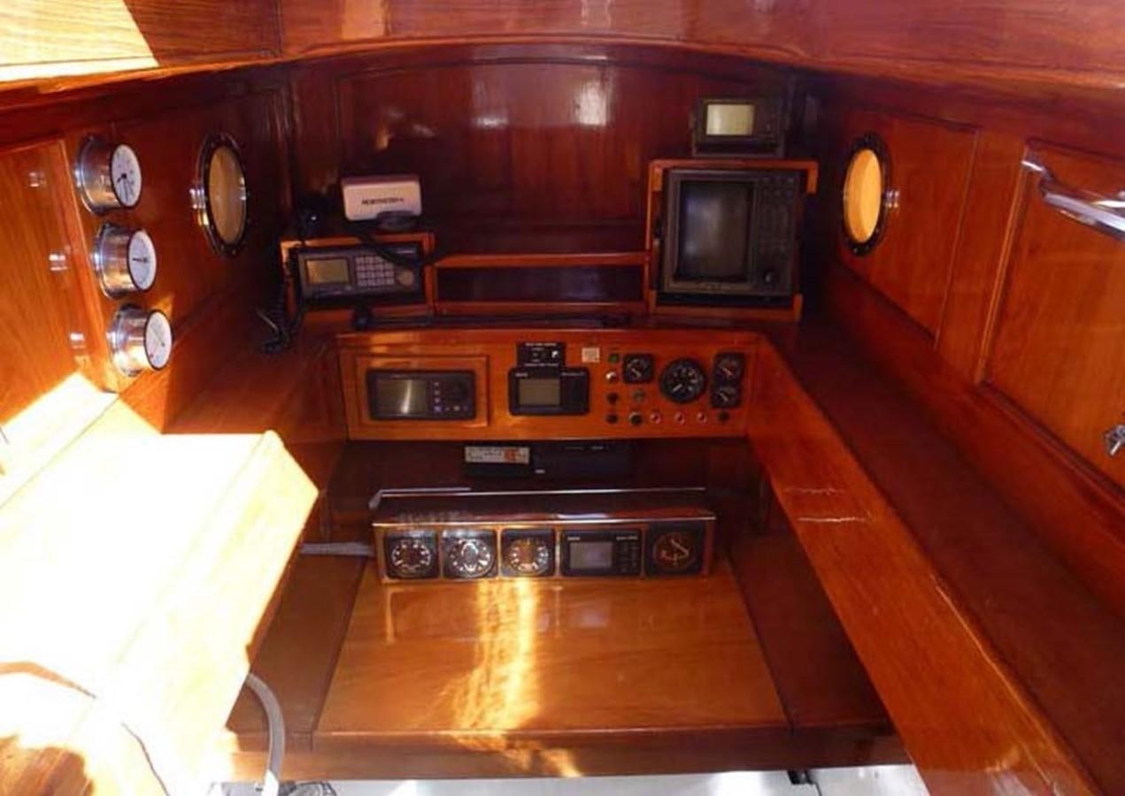 a kitchen with wooden cabinets aboard CANDIDA Yacht for Sale