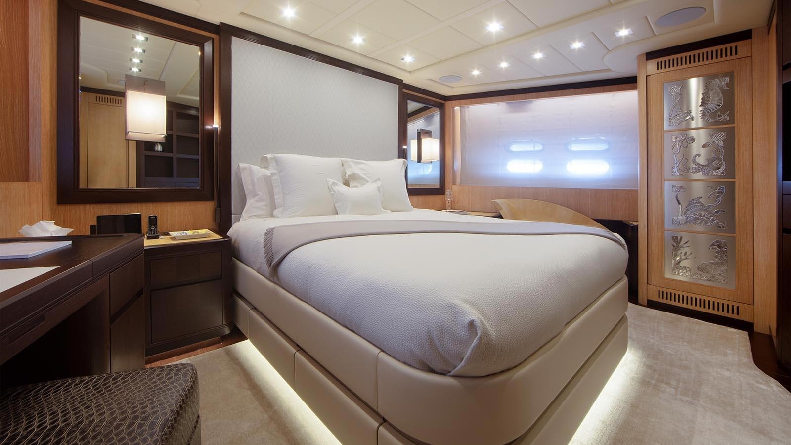 a large bedroom with a large mirror aboard YOU & G Yacht for Sale