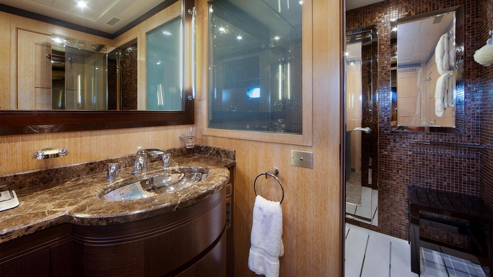 a bathroom with a sink and a mirror aboard YOU & G Yacht for Sale