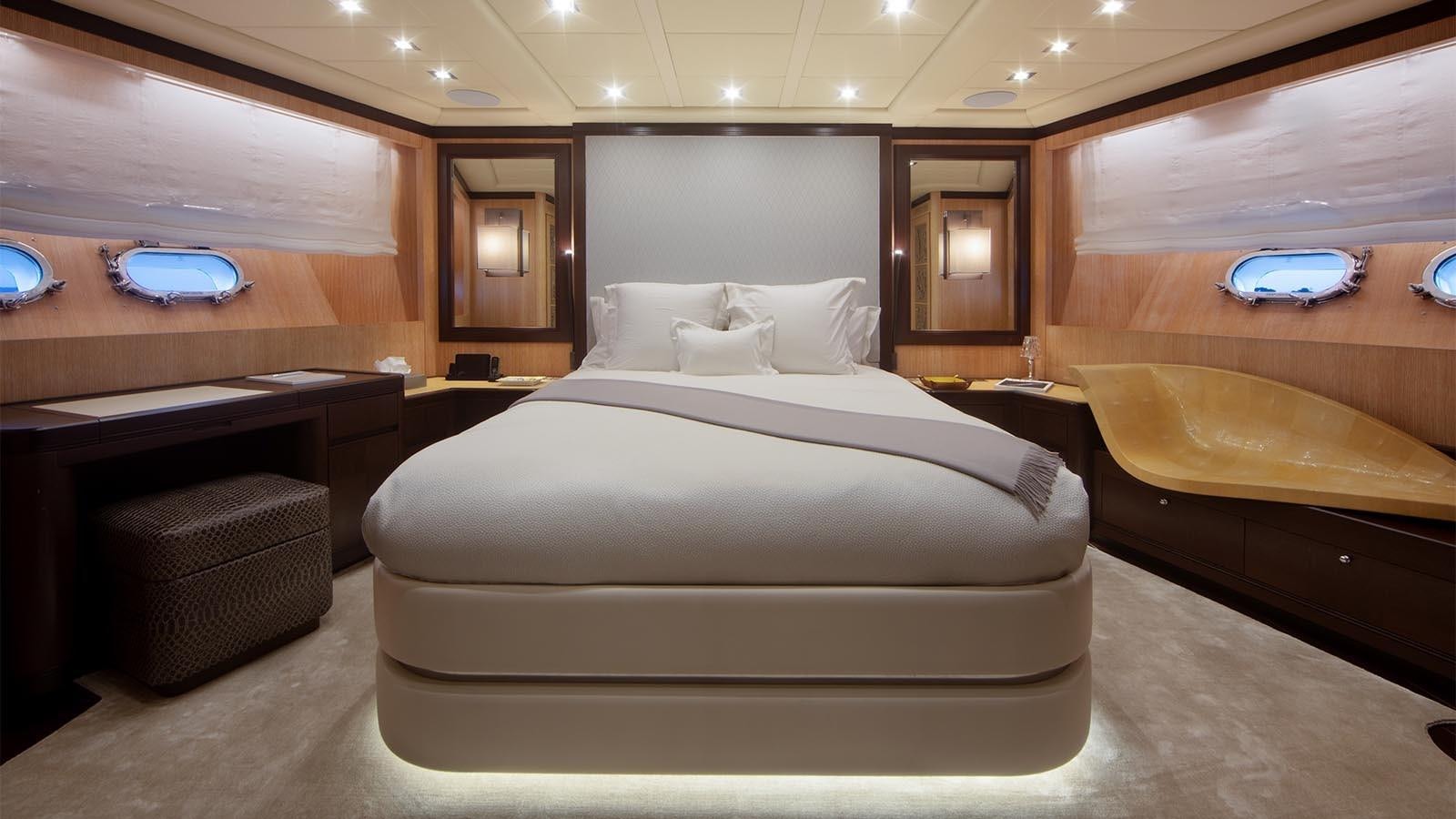 a room with a bed and a desk aboard YOU & G Yacht for Sale