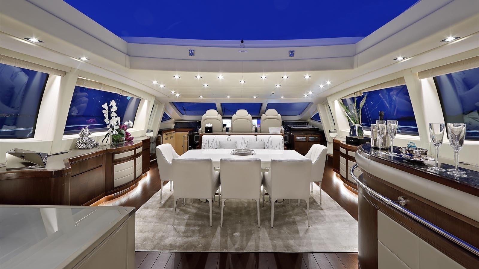 a room with a table chairs and a window aboard YOU & G Yacht for Sale