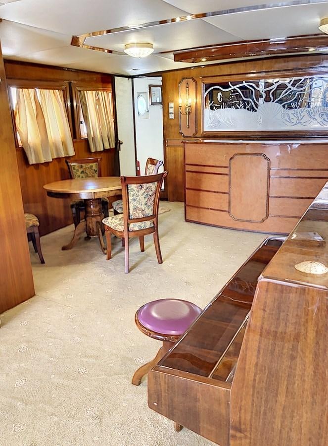 a room with a table and chairs aboard ELIKI Yacht for Sale