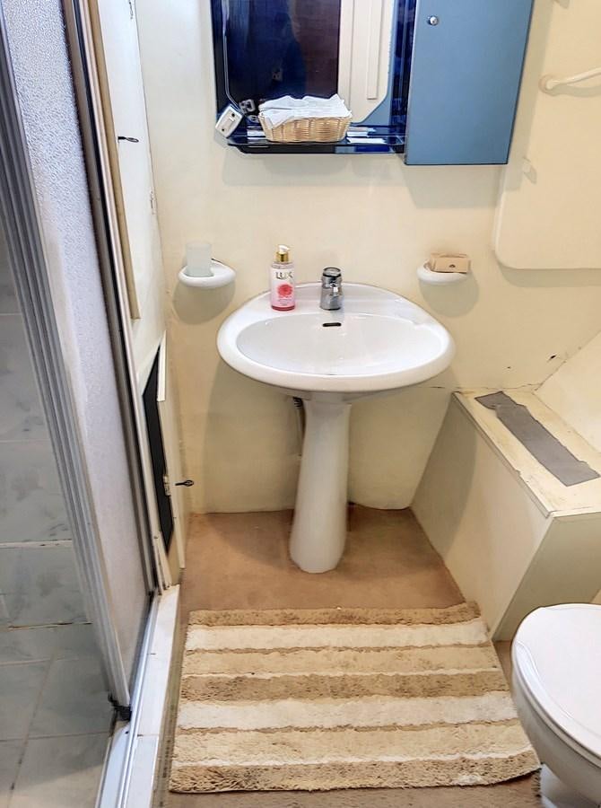 a bathroom with a sink and toilet aboard ELIKI Yacht for Sale