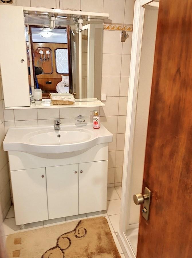 a bathroom with a sink and a mirror aboard ELIKI Yacht for Sale