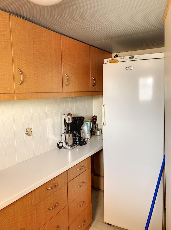 a kitchen with a refrigerator and a coffee maker aboard ELIKI Yacht for Sale