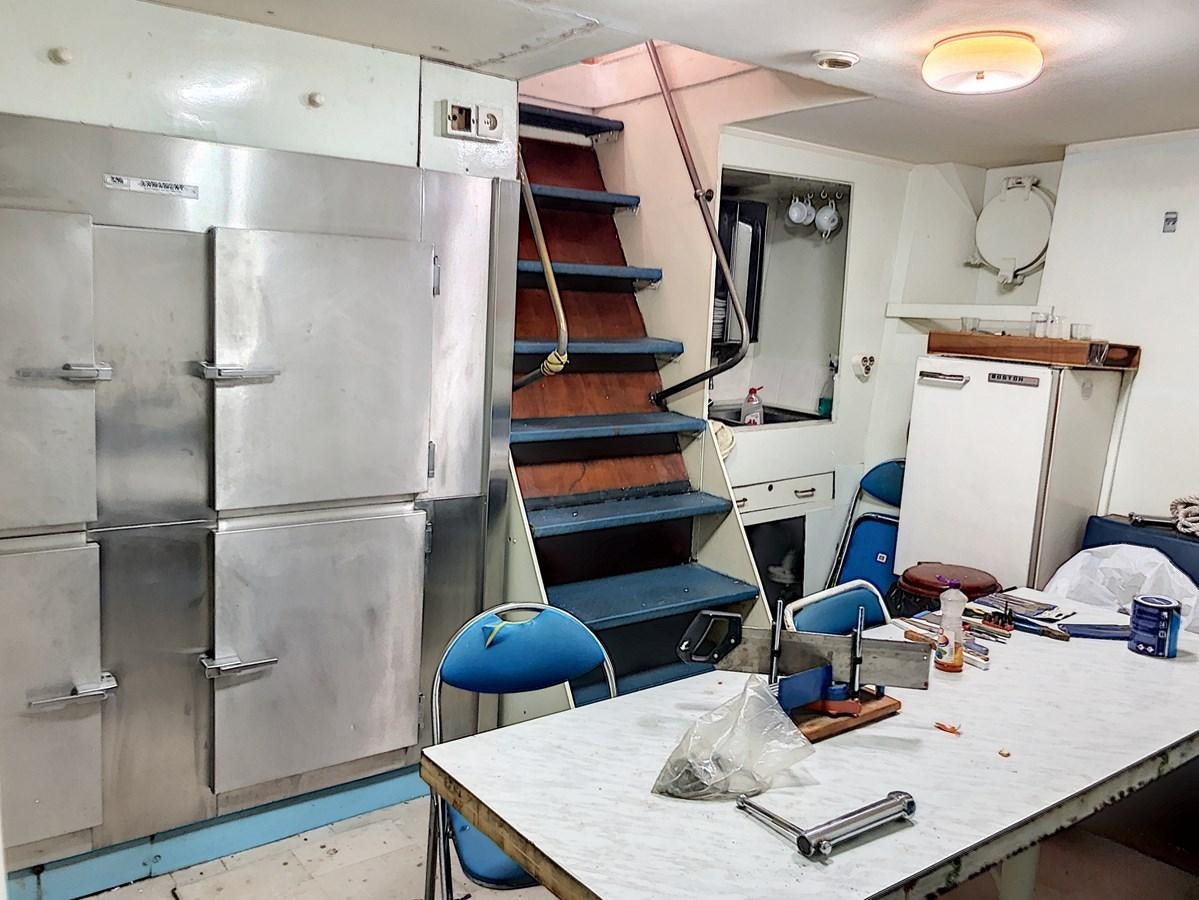 a room with a table and chairs aboard ELIKI Yacht for Sale